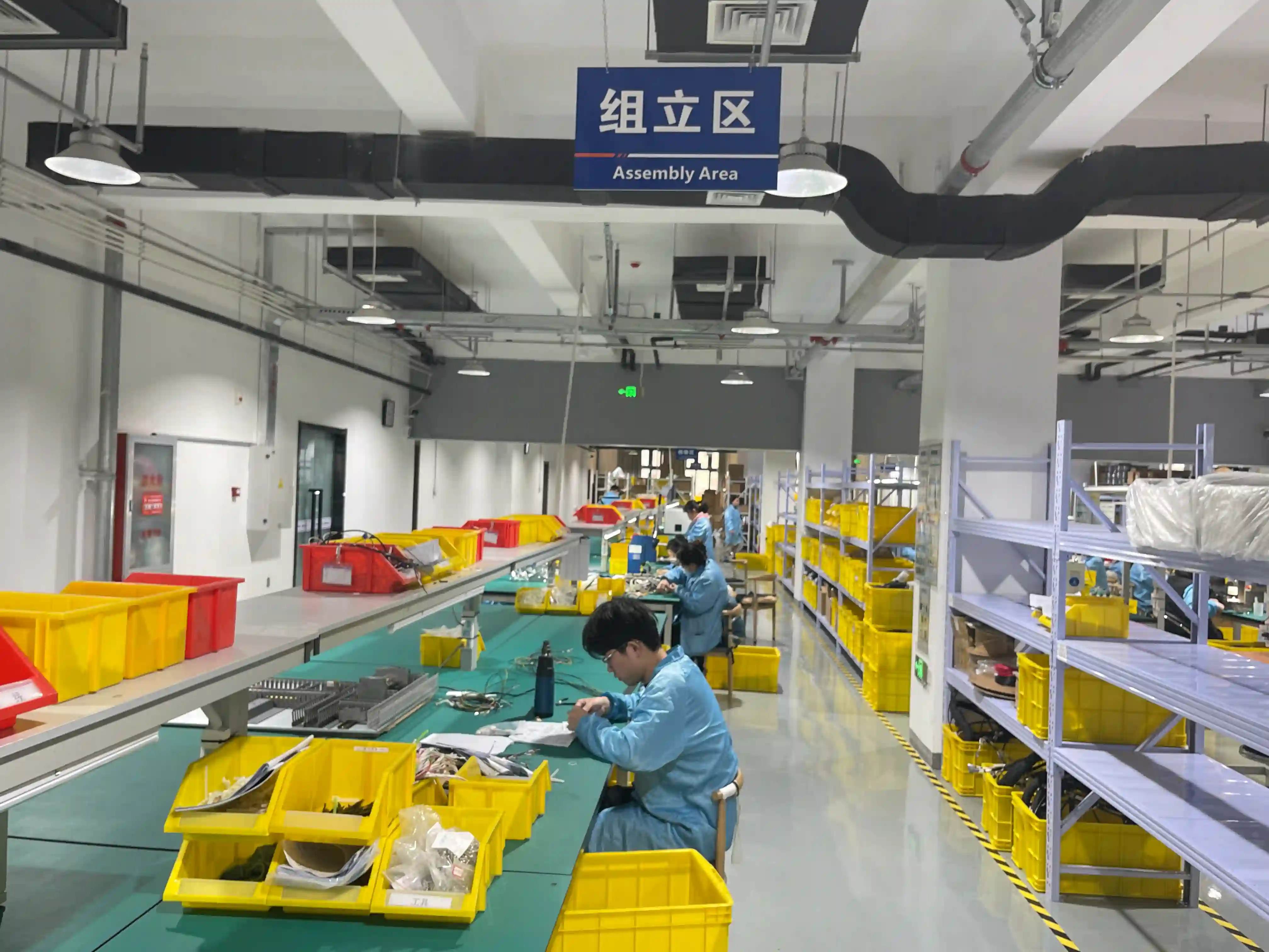Wire harness assembly workshop showing cable routing on formboard with proper bend radius management