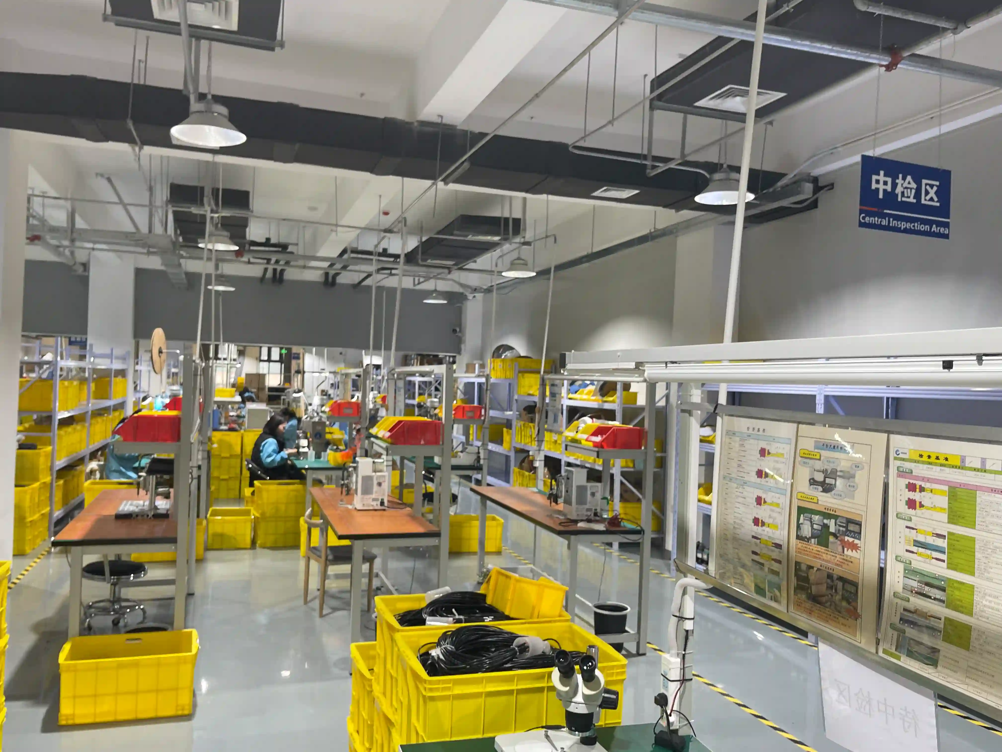 Quality inspection team verifying protected wire harness assemblies