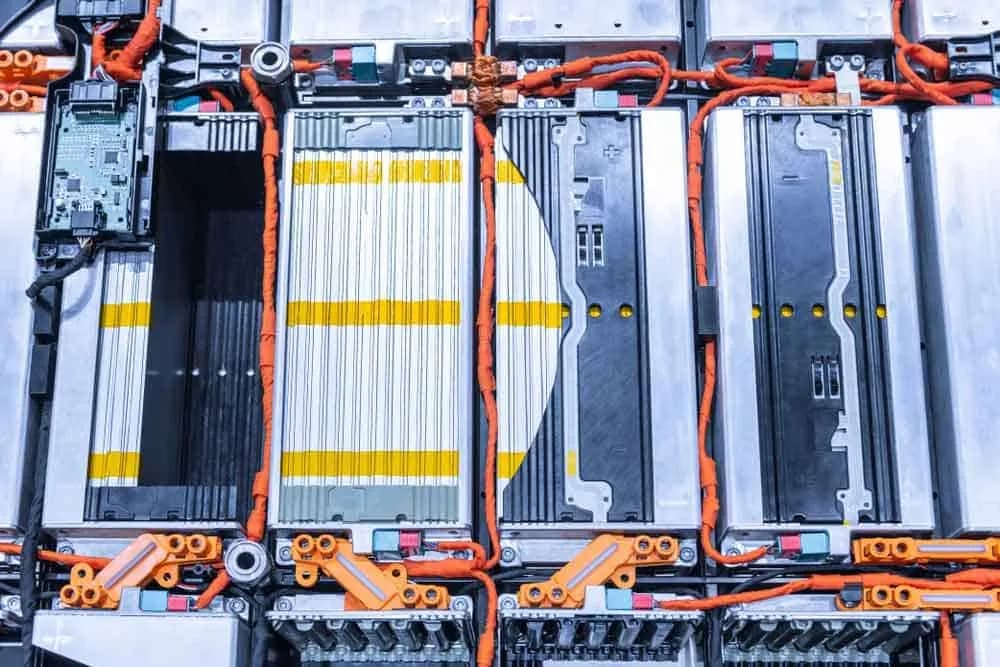 EV battery pack with thick orange insulated wires interconnecting cells for high voltage