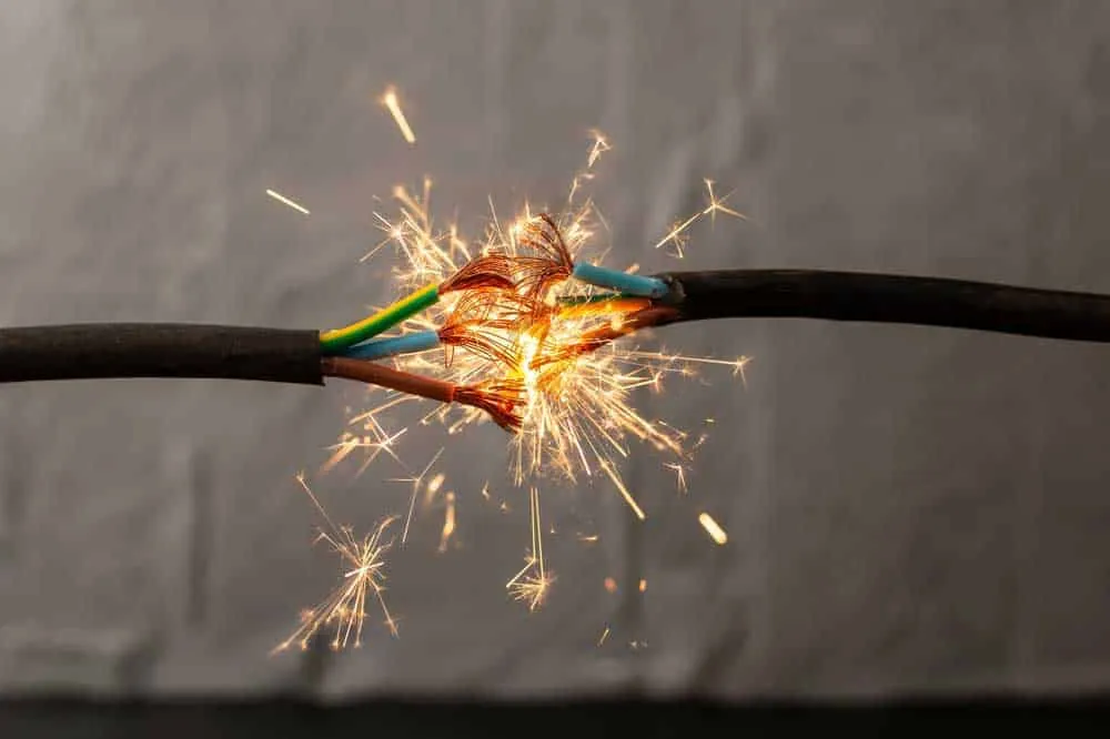 Electrical arcs between wire ends indicating insulation breakdown and safety hazard.